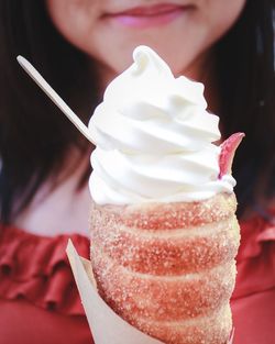 Midsection of woman eating ice cream cone