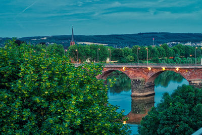 Arch bridge over river against sky