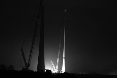 Low angle view of illuminated bridge against sky at night