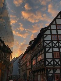 Low angle view of buildings against sky at sunset