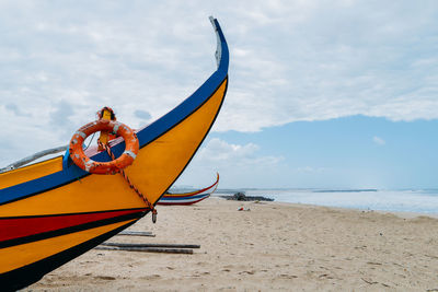 Ship on beach against sky