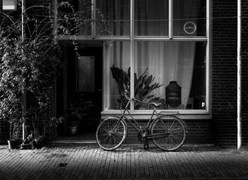 Bicycle parked against building