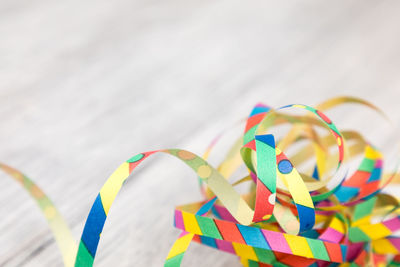 High angle view of multi colored streamers on wooden table