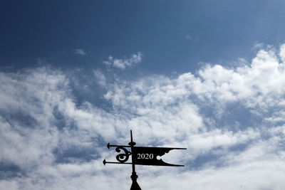 Low angle view of road sign against sky