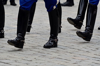 Low section of people in costume on road