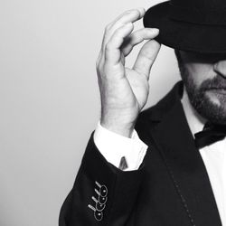 Midsection of man wearing hat against white background