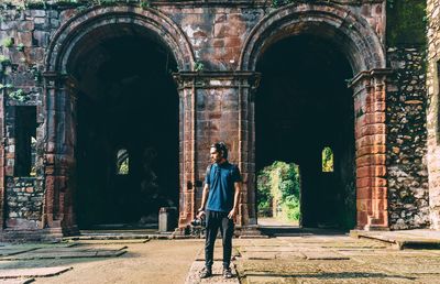 Full length of man standing against historic building