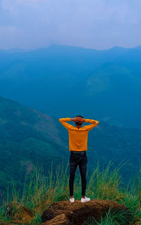 Rear view of man standing on mountain