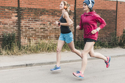 Two women running on the street