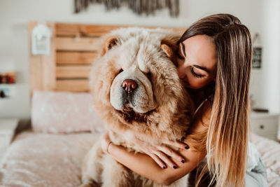 Young woman with dog at home