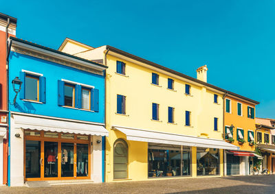 Low angle view of residential building against blue sky