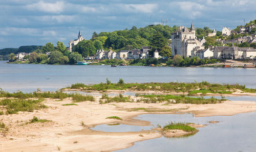 Scenic view of beach against buildings