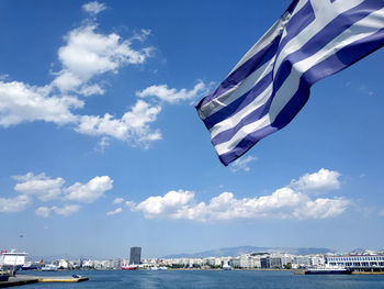 Scenic view of sea against blue sky. leaving piraeus port, greece. flag of greece. tones of blue