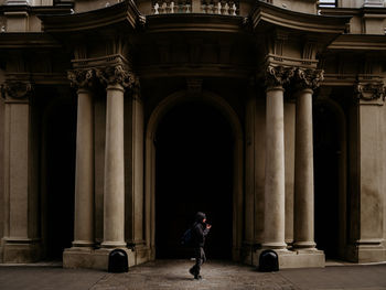 Rear view of man walking in building