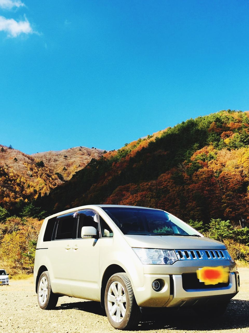 car, mountain, day, transportation, land vehicle, clear sky, nature, no people, outdoors, sunlight, tree, beauty in nature, road, landscape, sky