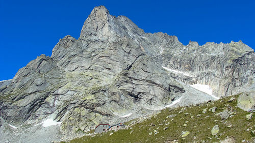 Low angle view of rock formation against sky