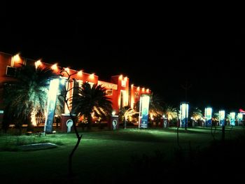 Illuminated street light in city at night