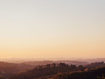 Scenic view of landscape against clear sky during sunset in toscan, italy