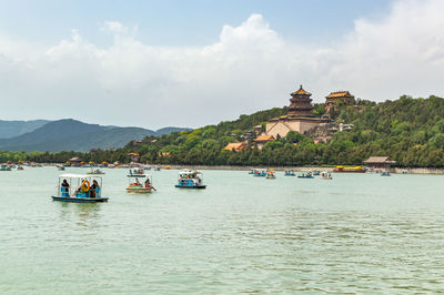 Boats in sea against buildings