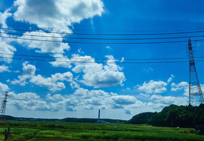 Electricity pylon on land against sky