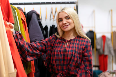 Portrait of smiling young woman standing in store