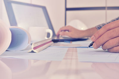 Midsection of man working on table