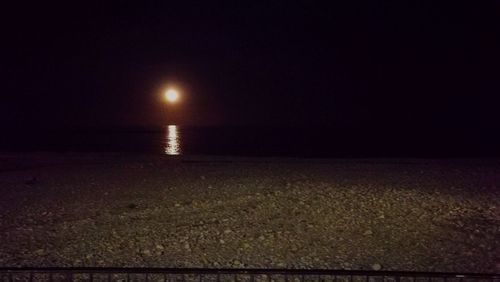 Scenic view of beach against sky at night