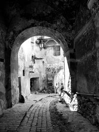 Empty alley amidst buildings in tunnel