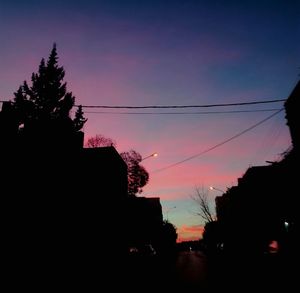 Silhouette trees against sky at sunset