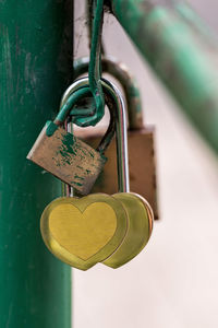 Close-up of heart shape padlocks on metal