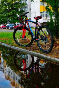 Bicycle with reflection of trees in water