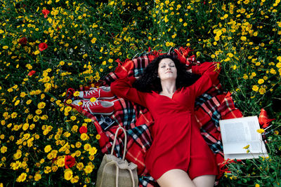 Full length of woman with red flowers