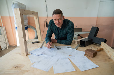 Side view of man working at office