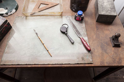 High angle view of tools n table at workshop