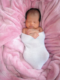 Close-up of baby sleeping on bed