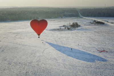 View of hot air balloon flying over land