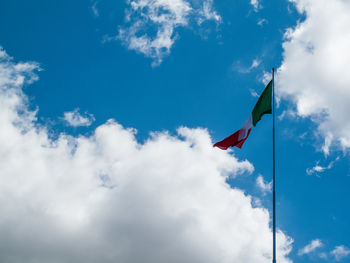 Low angle view of poles against blue sky