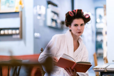 Portrait of woman holding book