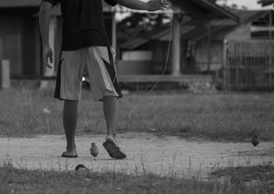 Low section of man standing on ground