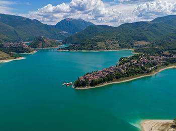 Aerial view of sea and mountains against sky