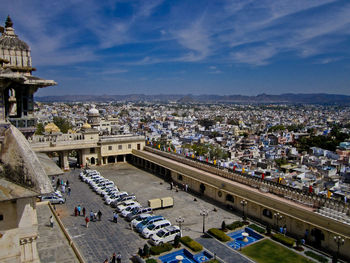 High angle view of city buildings against cloudy sky