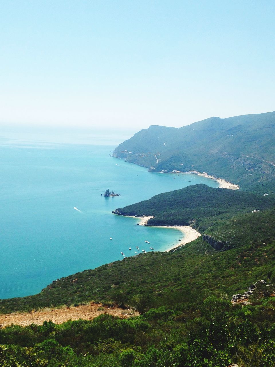 sea, water, tranquil scene, scenics, tranquility, mountain, beauty in nature, horizon over water, clear sky, blue, nature, high angle view, copy space, coastline, idyllic, landscape, mountain range, day, non-urban scene, remote