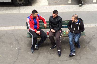 High angle view of two people sitting on street