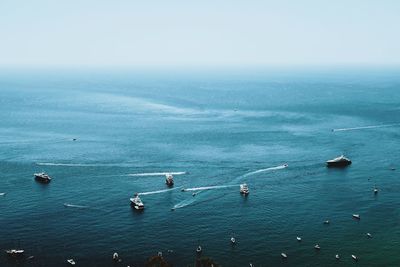 High angle view of sailboats in sea against sky