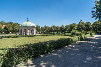 View of temple by building against sky