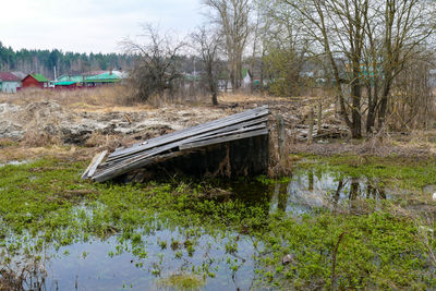 Abandoned bridge over river against sky