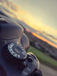 Close-up of vintage car against sky during sunset