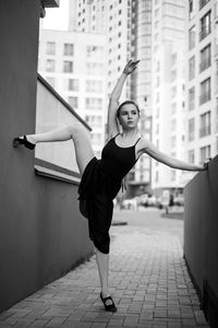 Full length of woman standing on city