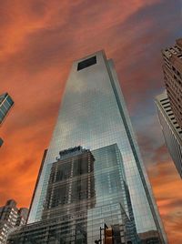 Low angle view of modern buildings against sky during sunset