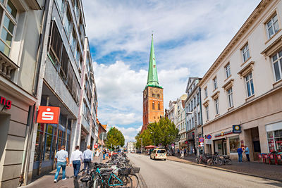 Street amidst buildings against sky in city